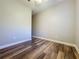 Simple bedroom with wood-look flooring and ceiling fan at 163 Crepe Myrtle Dr, Groveland, FL 34736