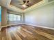 Bright bedroom with wood-look floors and large window at 163 Crepe Myrtle Dr, Groveland, FL 34736