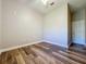 Simple bedroom with wood-look flooring and ceiling fan at 163 Crepe Myrtle Dr, Groveland, FL 34736