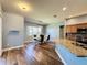 Modern dining room with hardwood floors and adjacent kitchen at 163 Crepe Myrtle Dr, Groveland, FL 34736