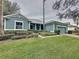 Charming single-story home features a well-manicured lawn and a brick walkway leading to the entrance at 163 Crepe Myrtle Dr, Groveland, FL 34736