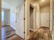 Long hallway with wood-look floors and access to other rooms at 163 Crepe Myrtle Dr, Groveland, FL 34736