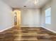 Living room with wood-look floors and neutral-colored walls at 163 Crepe Myrtle Dr, Groveland, FL 34736