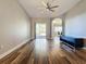 Open living room with wood-look floors, neutral walls, and ceiling fan at 163 Crepe Myrtle Dr, Groveland, FL 34736