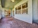 Screened porch with brick floor, ceiling fan and access to kitchen at 163 Crepe Myrtle Dr, Groveland, FL 34736