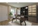 Modern home office with built-in shelving and a large work desk at 16369 Ingram Hills Aly, Winter Garden, FL 34787