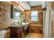 Elegant bathroom with double sinks, brown tile, and a shower at 1735 Lakeshore Dr, Mount Dora, FL 32757