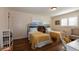 Bedroom with two twin beds, yellow bedding, and a white desk at 1735 Lakeshore Dr, Mount Dora, FL 32757