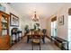 Formal dining room with a wooden table and chandelier at 1735 Lakeshore Dr, Mount Dora, FL 32757