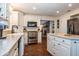 Kitchen with white cabinets, stainless steel appliances, and granite countertops at 1735 Lakeshore Dr, Mount Dora, FL 32757