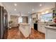 Eat-in kitchen with white cabinets, granite counters, and a brick feature wall at 1735 Lakeshore Dr, Mount Dora, FL 32757