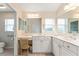 Double vanity bathroom with marble countertops and ample space at 1870 Saybrook Way, The Villages, FL 32162