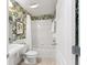 Small bathroom with tropical-themed wallpaper and tub at 1870 Saybrook Way, The Villages, FL 32162