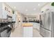 Kitchen features island, stainless steel appliances, and granite countertops at 1870 Saybrook Way, The Villages, FL 32162