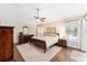 Large main bedroom with hardwood floors and ceiling fan at 1870 Saybrook Way, The Villages, FL 32162