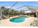 Relaxing kidney-shaped pool with screened enclosure, and plenty of seating at 1870 Saybrook Way, The Villages, FL 32162