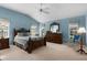 Relaxing bedroom with carpeted floor, large windows and ceiling fan at 1918 Yankee Clipper Run, The Villages, FL 32162