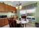 Kitchen breakfast nook with a glass table and four chairs at 1918 Yankee Clipper Run, The Villages, FL 32162