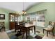 Charming dining room with wood table and chairs, and a window seat at 1918 Yankee Clipper Run, The Villages, FL 32162