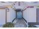 Inviting entryway with a light blue door and a brick-paved walkway at 1918 Yankee Clipper Run, The Villages, FL 32162