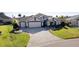 Aerial view of a house with a large driveway and lush lawn at 1918 Yankee Clipper Run, The Villages, FL 32162