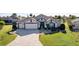 Aerial view of a house with a two-car garage and landscaped yard at 1918 Yankee Clipper Run, The Villages, FL 32162