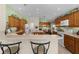 Modern kitchen with wood cabinets, island, and breakfast bar at 1918 Yankee Clipper Run, The Villages, FL 32162