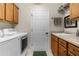 Bright laundry room with washer, dryer, and built-in cabinets at 1918 Yankee Clipper Run, The Villages, FL 32162