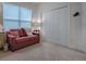 Cozy bedroom with red couch and double door closet at 2010 Allure Loop, The Villages, FL 32162