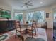 Spacious dining room with a round table and view to golf course at 2010 Allure Loop, The Villages, FL 32162