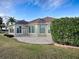 Back exterior of house with patio and landscaping at 2010 Allure Loop, The Villages, FL 32162