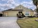 House exterior with two-car garage and landscaping at 2010 Allure Loop, The Villages, FL 32162