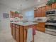 Kitchen with wood cabinets, island and breakfast bar at 2010 Allure Loop, The Villages, FL 32162