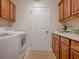 Convenient laundry room with washer, dryer, and cabinets at 2010 Allure Loop, The Villages, FL 32162