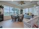 Bright sunroom with golf course view, daybed and wicker furniture at 2010 Allure Loop, The Villages, FL 32162