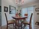 Cozy dining area with a unique heart-shaped table and four chairs at 2057 Countrywind Ct, The Villages, FL 32162