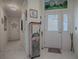 Bright and airy entryway with tile flooring and painted cabinet at 2057 Countrywind Ct, The Villages, FL 32162