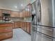 Kitchen with stainless steel refrigerator and granite countertops at 2057 Countrywind Ct, The Villages, FL 32162