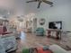 Spacious living area with hardwood floors and a large TV at 2057 Countrywind Ct, The Villages, FL 32162