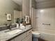 Updated bathroom features granite countertop, bathtub, and walk-in shower at 2078 Pink Blossom Ct, The Villages, FL 32162