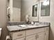 Bathroom with granite vanity and large mirror at 2078 Pink Blossom Ct, The Villages, FL 32162