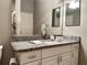 Bathroom with granite vanity and large mirror at 2078 Pink Blossom Ct, The Villages, FL 32162