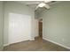 Well-lit bedroom with double door closet and wood-look floors at 2078 Pink Blossom Ct, The Villages, FL 32162