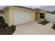 House exterior with a one-car garage and landscaping at 2078 Pink Blossom Ct, The Villages, FL 32162