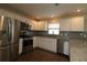 Bright kitchen featuring stainless steel appliances and white cabinets at 2078 Pink Blossom Ct, The Villages, FL 32162