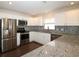 Spacious kitchen featuring granite countertops and white cabinetry at 2078 Pink Blossom Ct, The Villages, FL 32162