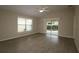 Living room with hardwood floors and sliding glass doors to patio at 2078 Pink Blossom Ct, The Villages, FL 32162