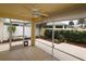 Relaxing screened porch with ceiling fan and view of backyard at 2078 Pink Blossom Ct, The Villages, FL 32162