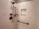 Walk-in shower with marble-look walls and bronze fixtures at 2078 Pink Blossom Ct, The Villages, FL 32162