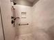 Walk-in shower with marble-look walls and bronze fixtures at 2078 Pink Blossom Ct, The Villages, FL 32162